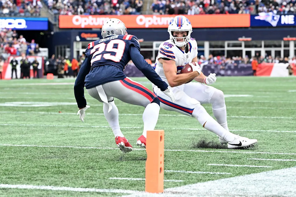 Oct 22, 2023; Foxborough, Massachusetts, USA; Buffalo Bills tight end Dalton Kincaid (86) runs against New England Patriots cornerback J.C. Jackson (29) during the second half at Gillette Stadium. Mandatory Credit: Brian Fluharty-USA TODAY Sports