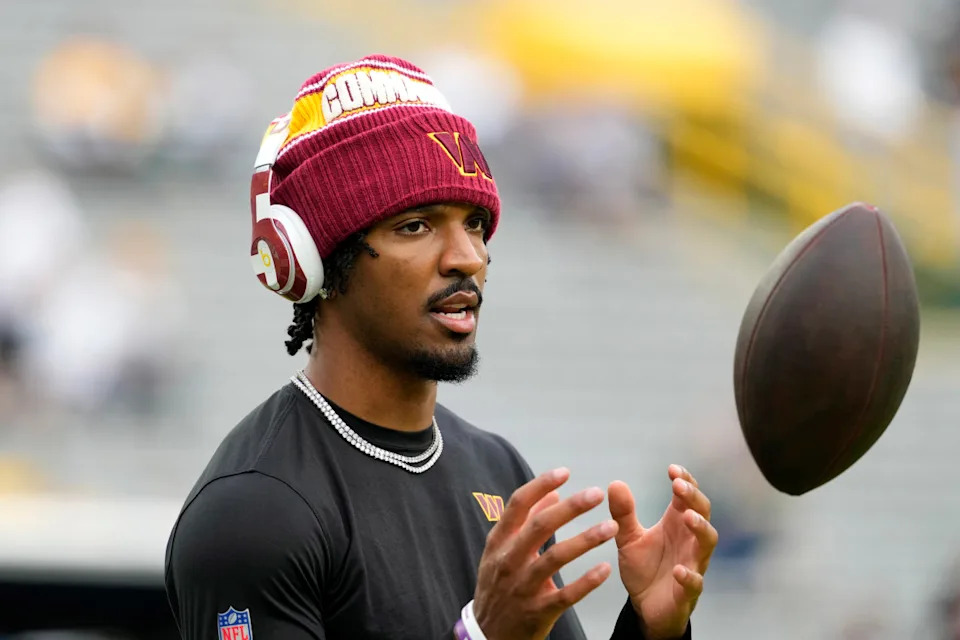 Sep 11, 2025; Green Bay, Wisconsin, USA; Washington Commanders quarterback Jayden Daniels (5) warms up before a game against the Green Bay Packers at Lambeau Field. Mandatory Credit: Jeff Hanisch-Imagn Images© Jeff Hanisch-Imagn Images