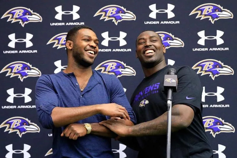 UFC fighter Jon Jones (L) jokes around with his brother defensive end Arthur Jones of the Baltimore Ravens during a news conference at the Raven's training facility Nov. 13, 2013 in Owings Mills, Maryland.