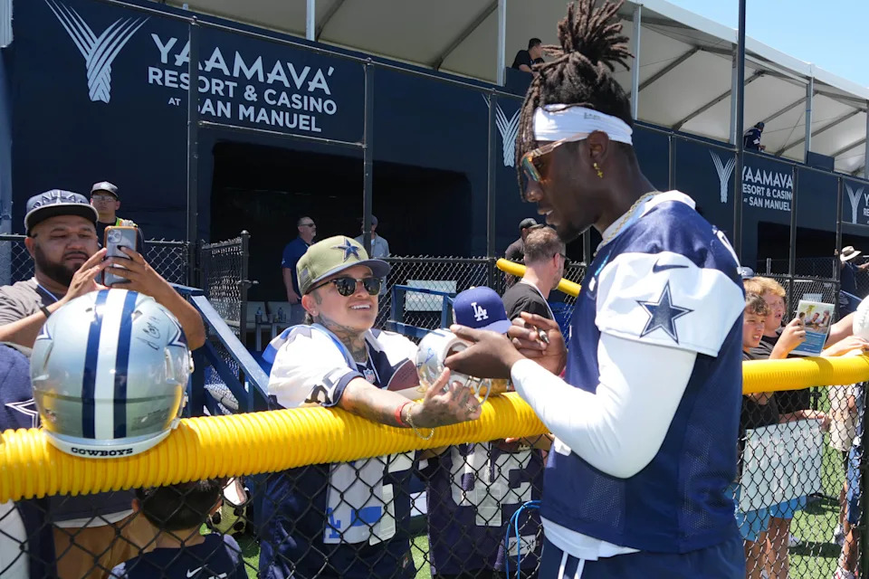 Jul 27, 2025; Oxnard, CA, USA; Dallas Cowboys linebacker DeMarvion Overshown (0) signs autographs at training camp at the River Ridge Fields. Mandatory Credit: Kirby Lee-Imagn Images