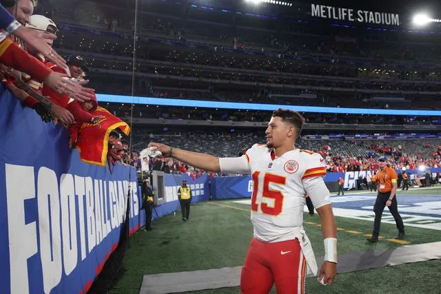 Elsa/Getty Patrick Mahomes gives his headband to fans on Sept. 21