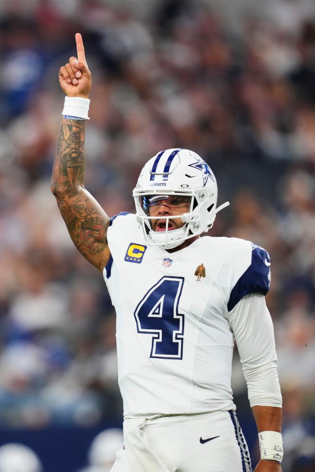 Dak Prescott #4 of the Dallas Cowboys celebrates after scoring a touchdown against the Washington Commanders