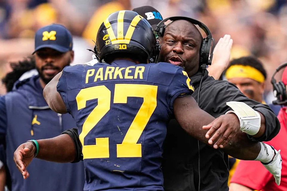 Michigan running backs coach Tony Alford hugs running back Jasper Parker (27) to celebrate his touchdown against Central Michigan during the second half at Michigan Stadium in Ann Arbor on Saturday, Sept. 13, 2025. © Junfu Han / USA TODAY NETWORK via Imagn Images