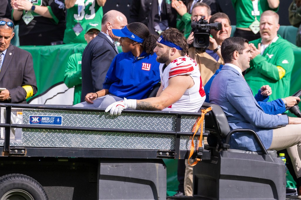 New York Giants running back Cam Skattebo is carted off the field.