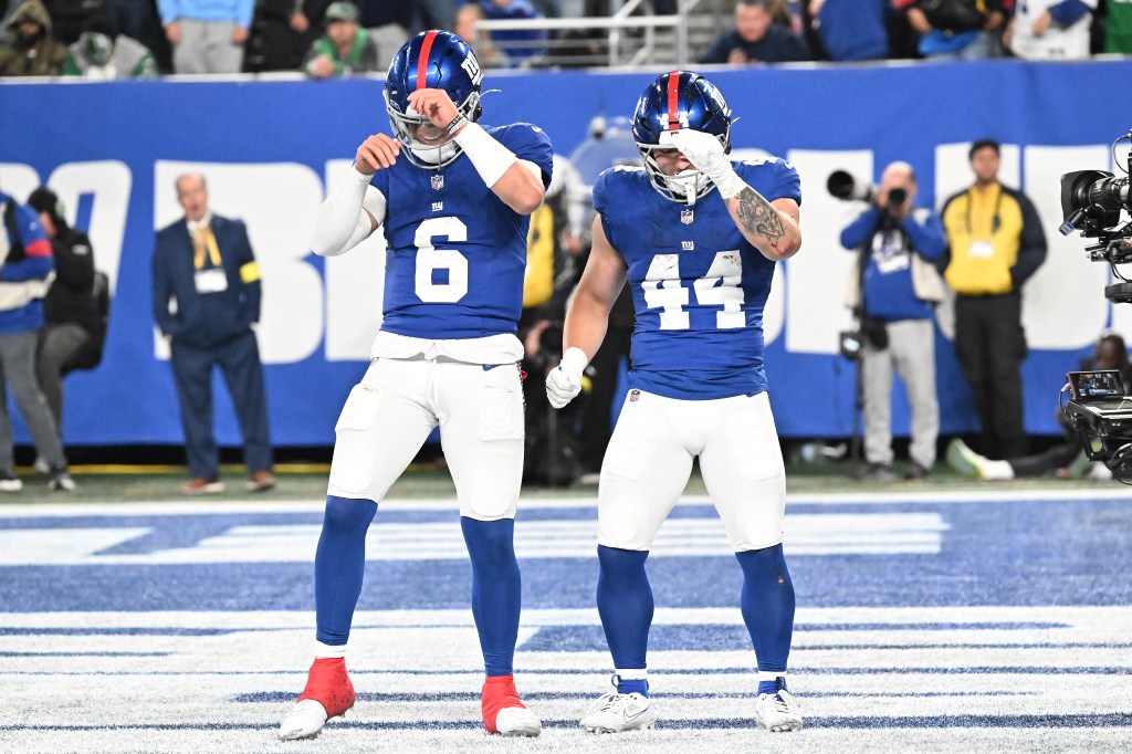 Jaxson Dart (L.) and Cam Skattebo celebrate during the Giants-Eagles game on Oct. 9, 2025. 