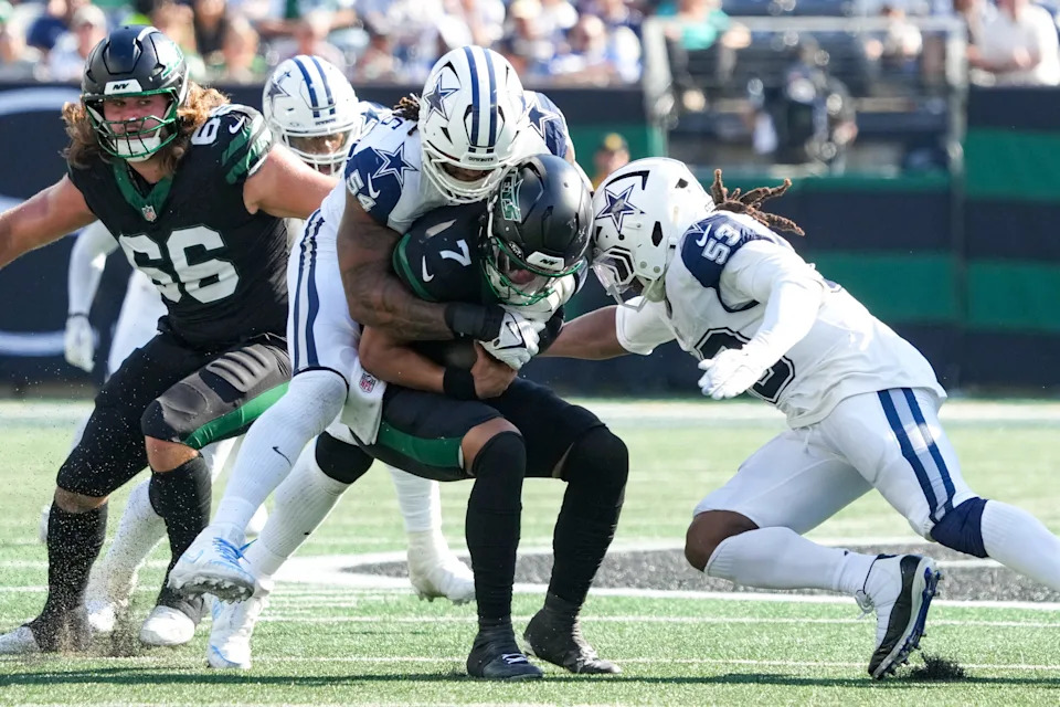 Oct 5, 2025; East Rutherford, New Jersey, USA; New York Jets quarterback Justin Fields (7) is sacked by Dallas Cowboys defensive end Sam Williams (54) during the second half at MetLife Stadium. Mandatory Credit: Robert Deutsch-Imagn Images