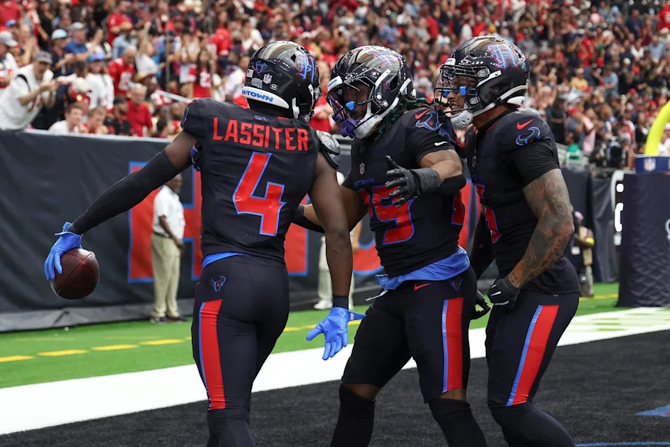 Houston Texans cornerback Kamari Lassiter celebrates with teammates after intercepting a pass.