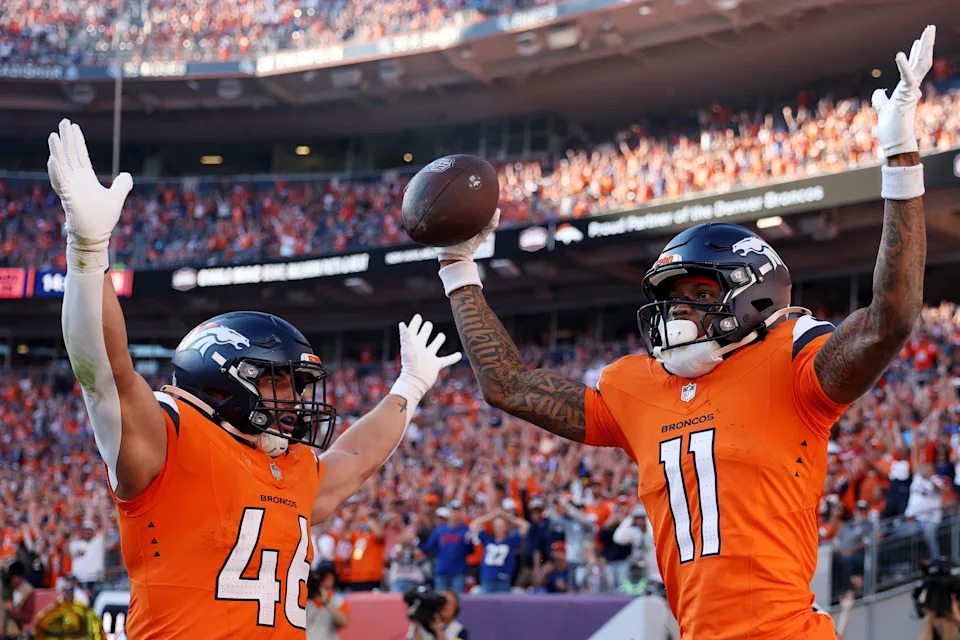 Adam Prentice #46 and Troy Franklin #11 of the Denver Broncos celebrate after Franklin's receiving touchdown in the fourth quarter of a game against the New York Giants at Empower Field At Mile High on October 19, 2025. (Photo by Matthew Stockman/Getty Images)