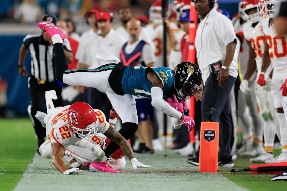 Jacksonville Jaguars wide receiver Travis Hunter (12) is shoved out of bounds by Kansas City Chiefs cornerback Trent McDuffie (22) and safety Bryan Cook (6) during the second quarter of an NFL football matchup at EverBank Stadium, Monday, Oct. 6, 2025, in Jacksonville, Fla. [Corey Perrine/Florida Times-Union]