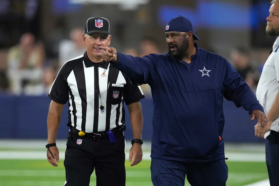 Aug 20, 2022; Inglewood, California, USA; Dallas Cowboys running backs coach Skip Peete (right) talks with line judge referee Jeff Seeman (45) in the second half against the Los Angeles Chargers at SoFi Stadium. Mandatory Credit: Kirby Lee-USA TODAY Sports© Kirby Lee-Imagn Images
