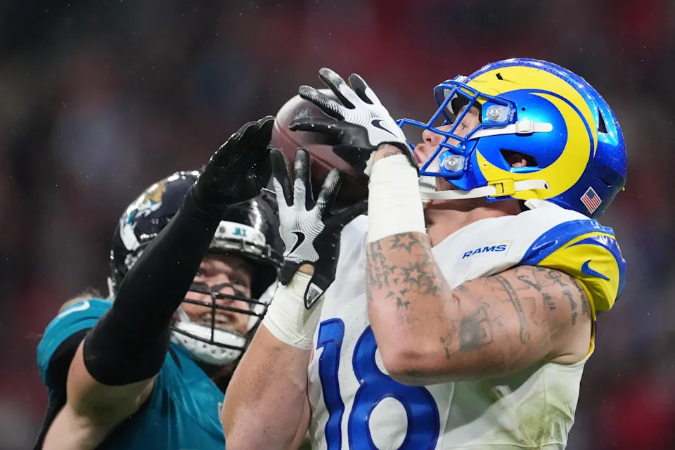 Oct 19, 2025; London, United Kingdom; Los Angeles Rams tight end Terrance Ferguson (18) makes a catch against Jacksonville Jaguars safety Andrew Wingard (42) during the second half of an NFL International Series game at Wembley Stadium. Mandatory Credit: Kirby Lee-Imagn Images