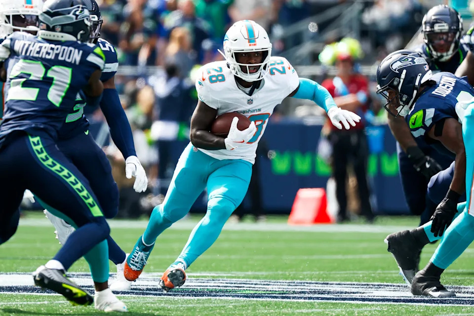 Sep 22, 2024; Seattle, Washington, USA; Miami Dolphins running back DeVon Achane (28) rushes against the Seattle Seahawks during the first quarter at Lumen Field. Mandatory Credit: Joe Nicholson-Imagn Images