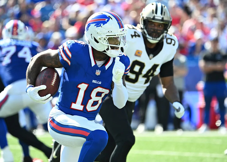 Sep 28, 2025; Orchard Park, New York, USA; Buffalo Bills wide receiver Elijah Moore (18) runs for a gain past New Orleans Saints defensive end Cameron Jordan (94) during the second quarter at Highmark Stadium. Mandatory Credit: Mark Konezny-Imagn Images