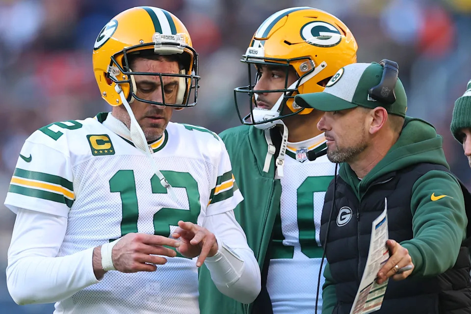 CHICAGO, ILLINOIS - DECEMBER 04: Aaron Rodgers #12, Jordan Love #10 and head coach Matt LaFleur of the Green Bay Packers look on during the fourth quarter of the game against the Chicago Bears at Soldier Field on December 04, 2022 in Chicago, Illinois. (Photo by Michael Reaves/Getty Images)
