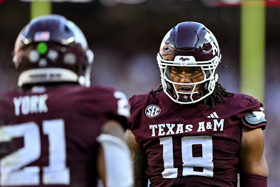 Sep 27, 2025; College Station, Texas, USA; Texas A&M Aggies defensive end T.J. Searcy (18) congratulates linebacker Taurean York (21) after a sack in the second half against the Auburn Tigers at Kyle Field. Mandatory Credit: Maria Lysaker-Imagn Images