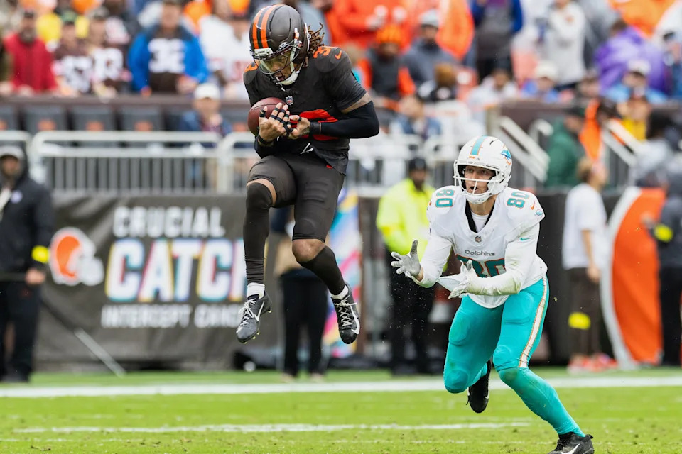 Oct 19, 2025; Cleveland, Ohio, USA; Cleveland Browns safety Ronnie Hickman Jr. (33) intercepts a pass intended for Miami Dolphins tight end Tanner Conner (80) during the fourth quarter at Huntington Bank Field. Mandatory Credit: Scott Galvin-Imagn Images