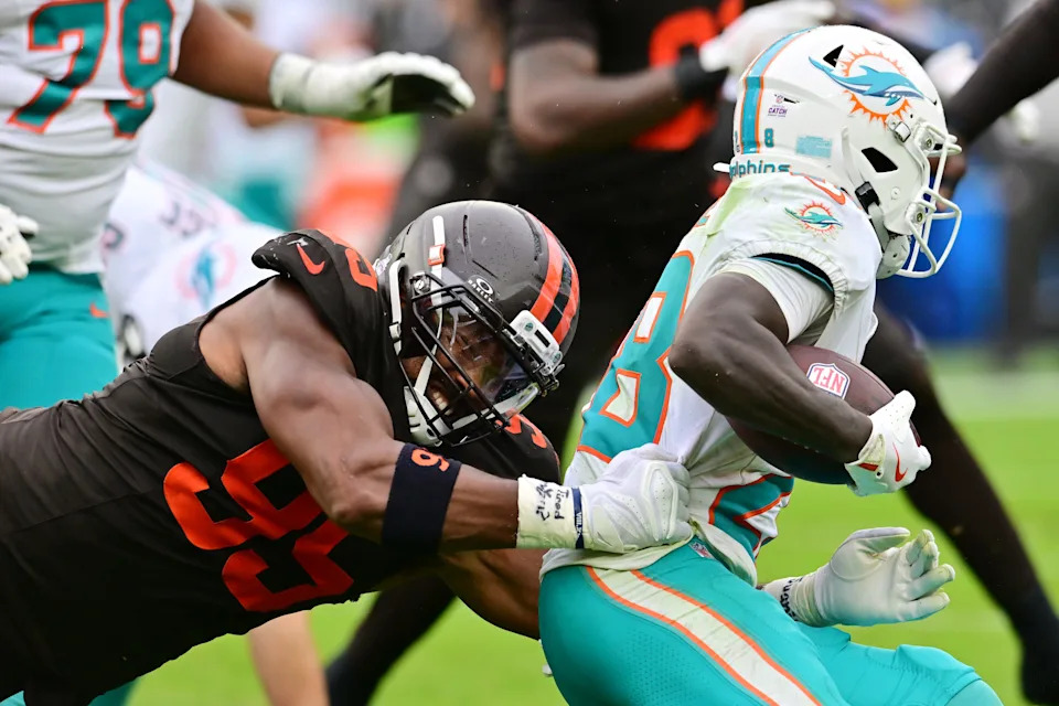 Oct 19, 2025; Cleveland, Ohio, USA; Cleveland Browns defensive end Myles Garrett (95) tackles Miami Dolphins running back De'Von Achane (28) during the second half at Huntington Bank Field. Mandatory Credit: Ken Blaze-Imagn Images