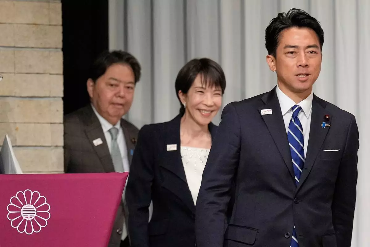 FILE - From left, Japan's chief Cabinet Secretary Yoshimasa Hayashi, former Economic Security Minister Sanae Takaichi and Agriculture Minister Shinjiro Koizumi walk into the stage for a joint press conference by the Liberal Democratic Party (LDP) presidential election candidates at the party's headquarters Tuesday, Sept. 23, 2025, in Tokyo. (AP Photo/Eugene Hoshiko, Pool, File)