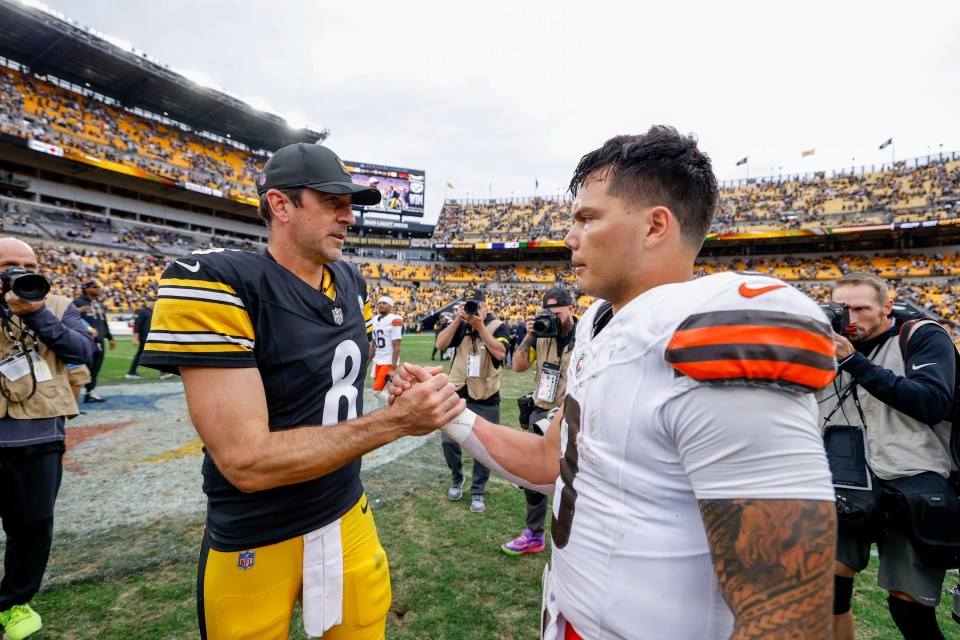 Aaron Rodgers and Dillon Gabriel shake hands after a game