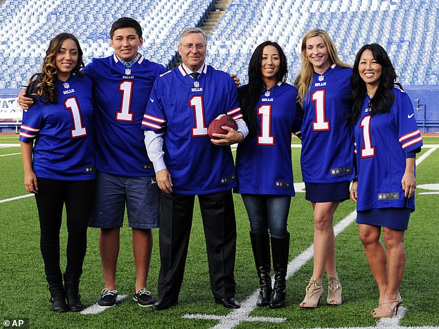 Pegula, left is seen with her family after her parents Terry (center) and Kim (right) bought the Buffalo Bills in 2014