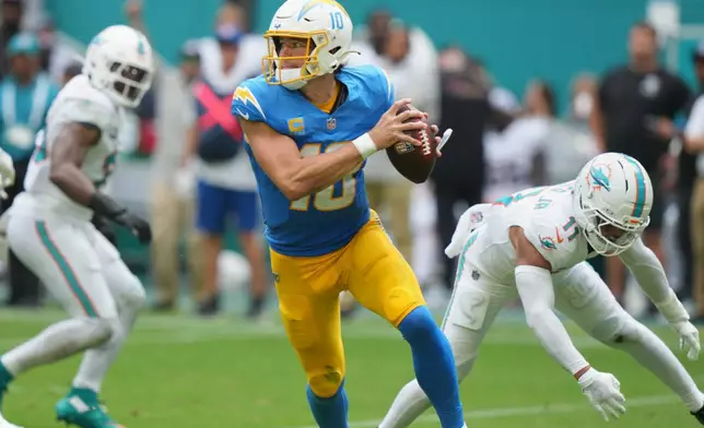 Los Angeles Chargers quarterback Justin Herbert scrambles during the second half of an NFL football game against the Miami Dolphins Sunday, Oct. 12, 2025, in Miami Gardens, Fla. (AP Photo/Lynne Sladky)