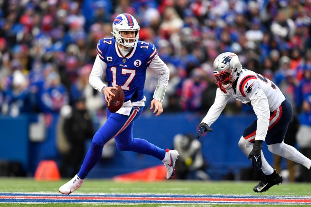 Buffalo Bills quarterback Josh Allen (17) looks to pass on the run during the second half of an NFL game against the New England Patriots on Sunday, Jan. 8, 2023 in Orchard Park. (AP Photo/Adrian Kraus)