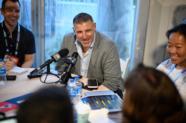 New England Patriots head football coach Mike Vrabel, center, talks with reporters during the 2025 NFL annual meetings on Monday, March 31, 2025 in Palm Beach, Fla. (Phelan M. Ebenhack/AP Content Services for the NFL)