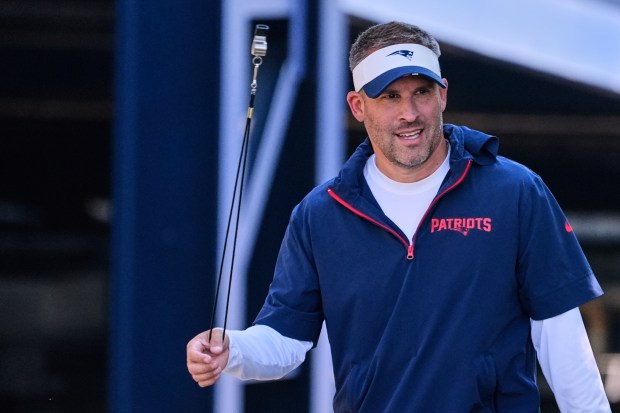 New England Patriots offensive coordinator Josh McDaniels twirls a whistle while walking to the practice field at the team's NFL football training camp, Wednesday, July 30, 2025, in Foxborough, Mass. (AP Photo/Charles Krupa)