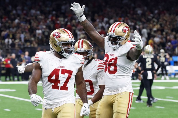 San Francisco 49ers defensive end Bryce Huff (47) celebrates with cornerback Upton Stout, rear, and defensive end Mykel Williams (98) after sacking New Orleans Saints quarterback Spencer Rattler (2) to force a turnover on downs during the second half of an NFL football game in New Orleans, Sunday, Sept. 14, 2025. (AP Photo/Butch Dill)