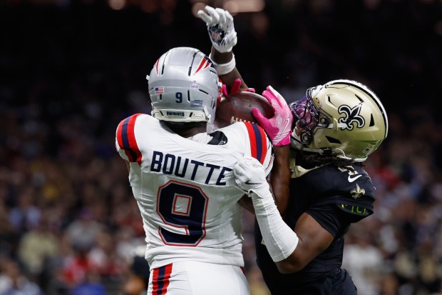 New England Patriots wide receiver Kayshon Boutte, left, catches a pass for a touchdown against New Orleans Saints cornerback Kool-Aid McKinstry during the first half of an NFL football game, Sunday, Oct. 12, 2025, in New Orleans. (AP Photo/Butch Dill)