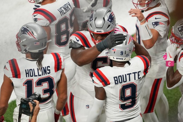 New England Patriots wide receiver Kayshon Boutte celebrates with teammates after catching a pass for a touchdown during the first half of an NFL football game against the New Orleans Saints, Sunday, Oct. 12, 2025, in New Orleans. (AP Photo/Gerald Herbert)