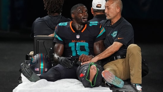 Miami Dolphins wide receiver Tyreek Hill (10) talks with a staff member as he is carted off the field.(AP)