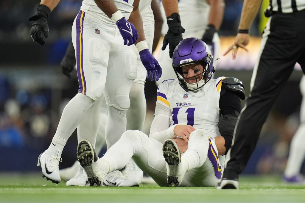 Minnesota Vikings quarterback Carson Wentz (11) sits on the ground after a hit during the second half of an NFL football game against the Los Angeles Chargers Thursday, Oct. 23, 2025, in Inglewood, Calif. 