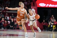 Oklahoma guard Zya Vann (3) drives past Texas forward Justice Carlton (11) during the first...