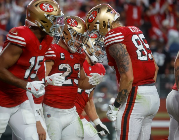 San Francisco 49ers' Christian McCaffrey (23) is congratulated on his touchdown by San Francisco 49ers' George Kittle (85) against the Atlanta Falcons in the second quarter at Levi's Stadium in Santa Clara, Calif., on Sunday, Oct. 19, 2025. (Nhat V. Meyer/Bay Area News Group)