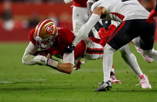 San Francisco 49ers starting quarterback Mac Jones (10) dives for yards against Atlanta Falcons' Jessie Bates III (3) in the fourth quarter at Levi's Stadium in Santa Clara, Calif., on Sunday, Oct. 19, 2025. (Nhat V. Meyer/Bay Area News Group)