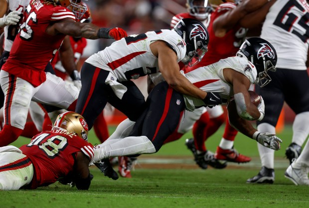 San Francisco 49ers' Tatum Bethune (48) tackles Atlanta Falcons' Bijan Robinson (7) in the fourth quarter at Levi's Stadium in Santa Clara, Calif., on Sunday, Oct. 19, 2025. (Nhat V. Meyer/Bay Area News Group)