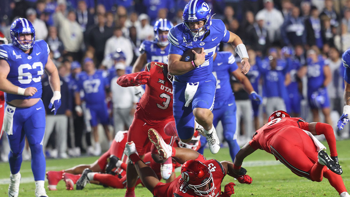BYU Cougars quarterback Bear Bachmeier (47) runs for a touchdown against Utah Utes defensive tackle Pupu Sepulona (45), cornerback Elijah Davis (9) and linebacker Levani Damuni (3) during the second half at LaVell Edwards Stadium.
