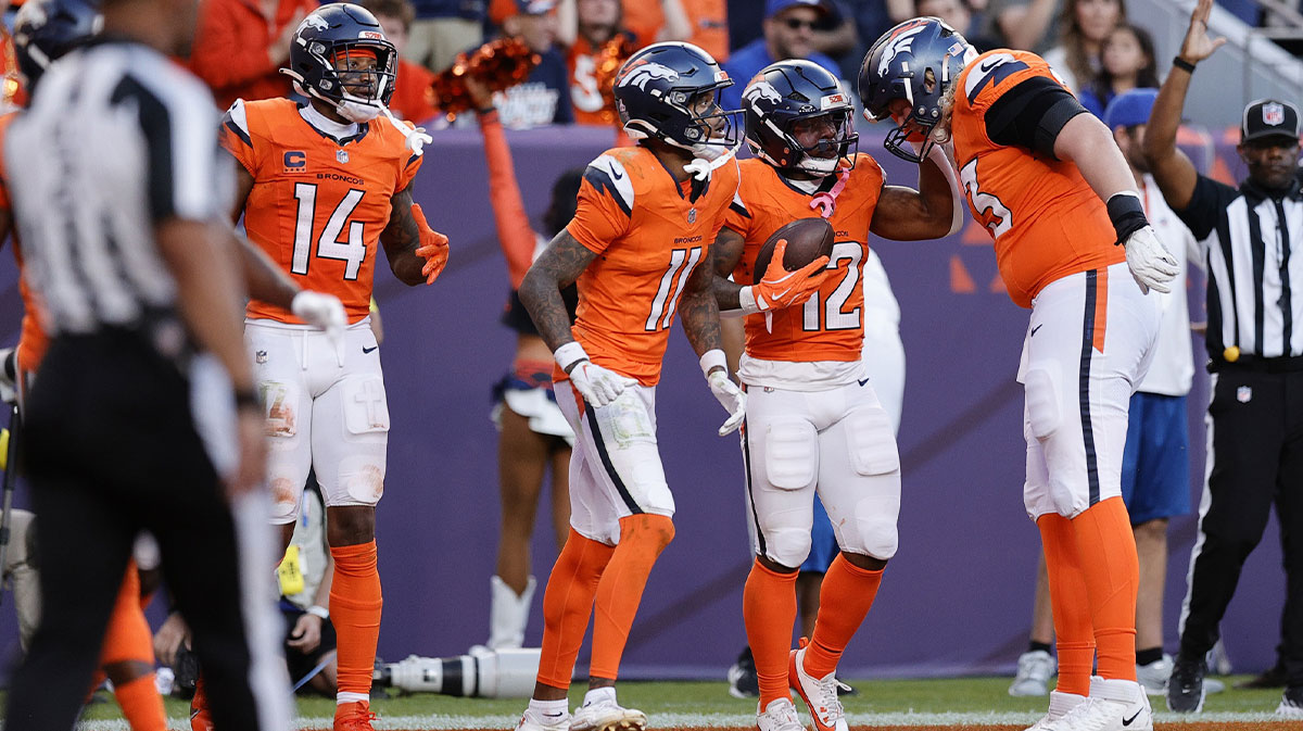 Denver Broncos wide receiver Troy Franklin (11) and Denver Broncos cornerback Jahdae Barron (12) celebrate the win against the New York Giants at Empower Field at Mile High. 