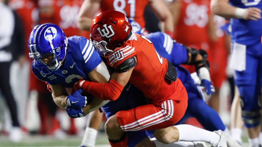 Smith Snowden #2 of the Utah Utes tackles Chase Roberts #2 BYU football...