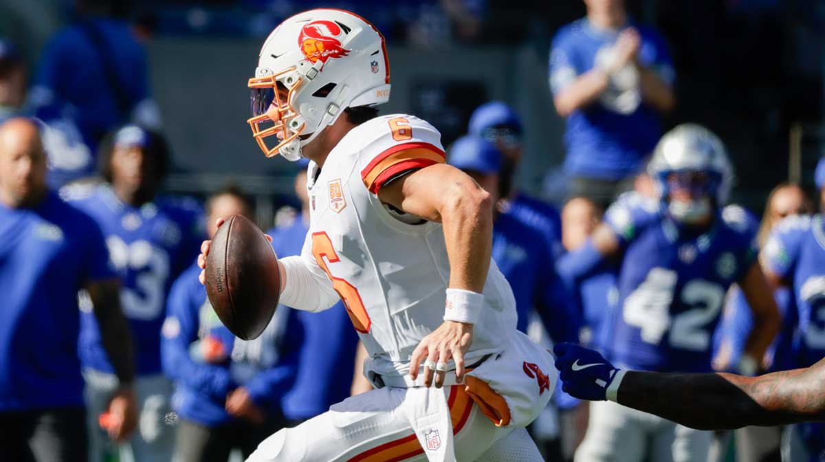 Oct 5, 2025; Seattle, Washington, USA; Tampa Bay Buccaneers quarterback Baker Mayfield (6) carried the ball against the Seattle Seahawks during the first half at Lumen Field.