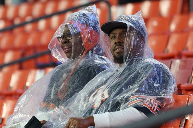 Two fans watch warmups before a Bears-Commanders game at Northwest Stadium Oct. 13, 2025, in Landover, Maryland. (John J. Kim/Chicago Tribune)