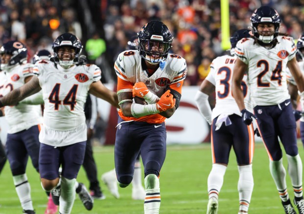 Bears safety Jaquan Brisker heads to the end zone with...