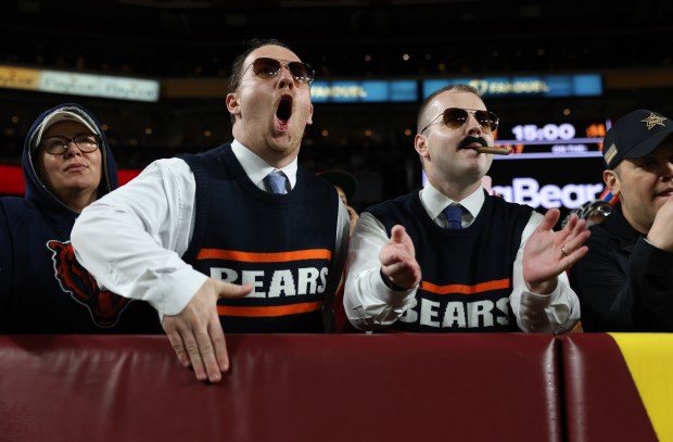 Bears fans dressed like Mike Ditka cheer on the team...
