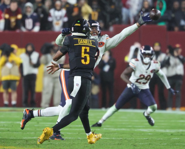 Bears defensive end Montez Sweat deflects a pass from Commanders...