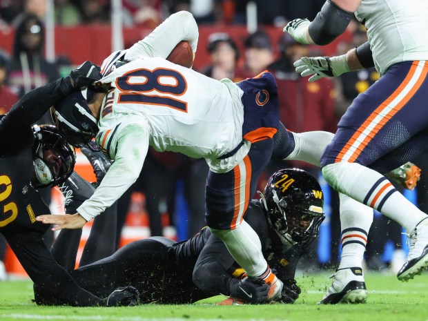 Bears quarterback Caleb Williams (18) is sacked by Commanders defensive...