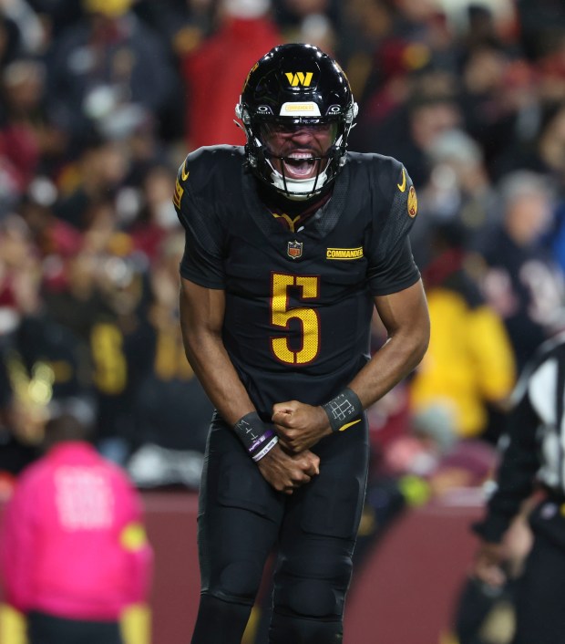 Washington Commanders quarterback Jayden Daniels (5) celebrates his touchdown pass...