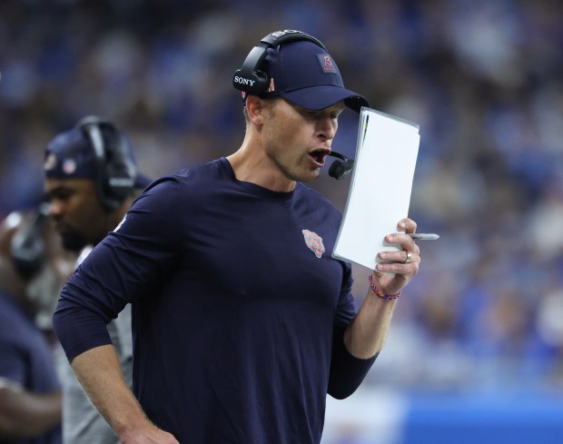 Bears coach Ben Johnson goes over plays in the second quarter against the Lions at Ford Field on Sept. 14, 2025, in Detroit. (John J. Kim/Chicago Tribune)