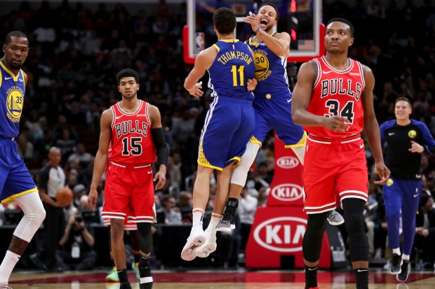 Golden State Warriors guard Klay Thompson (11) and Golden State Warriors guard Stephen Curry (30) celebrate after the Chicago Bulls called a timeout during the first half at the United Center on Oct. 29, 2018, in Chicago. (Armando L. Sanchez/Chicago Tribune)