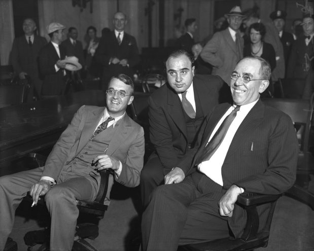 Al Capone, center, is in federal court in Chicago with his lawyers Michael Ahern, left and Albert Fink during his 1931 tax-evasion trial. (Chicago Herald and Examiner)